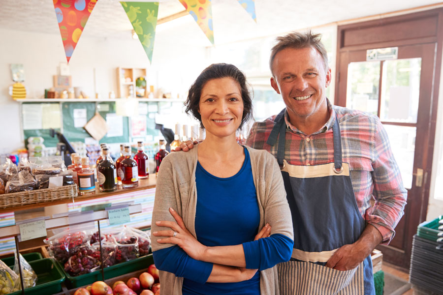 Business Insurance - Shop Owners in Front of an Organic Fruit Stand