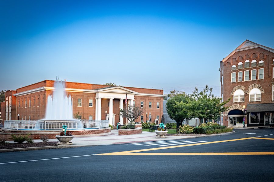 City center fountain and the Pulaski County government office in Somerset, Kentucky, during the morning hours under a clear sky.